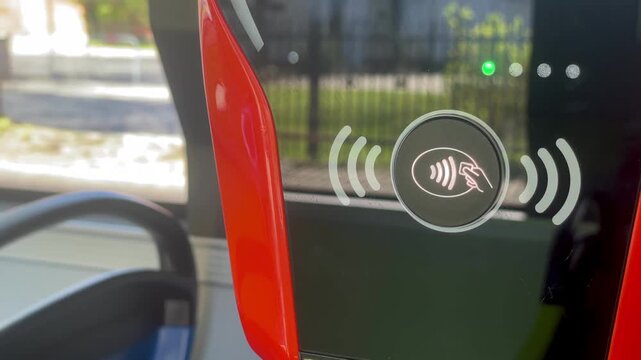 Close-up of a contactless payment validator inside an electric bus.