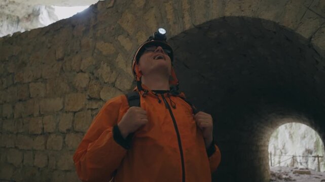 Thrilled Explorer Marvels at Ancient Cave Interior