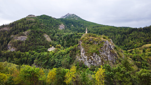 Clocher Saint Julien de M&eacute;olans bell tower rising above a river, French Alps, Alpes-de-Haute-Provence, France, Europe.