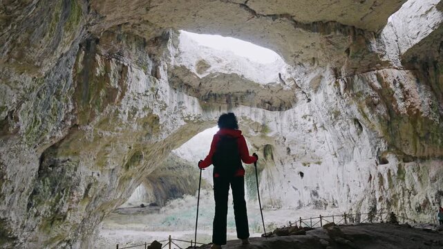 Hiker Woman Explores Majestic Devetashka Cave in Bulgaria