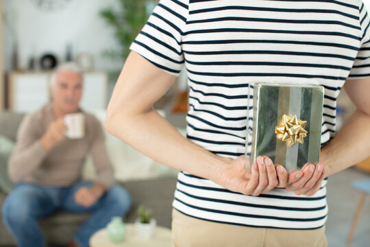 son is giving a present to his senior dad