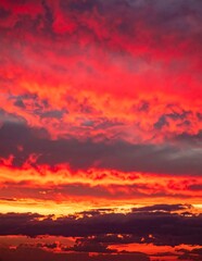 Fototapeta premium Vibrant Red and Orange Sunset Sky with Dramatic Cloud Formations.