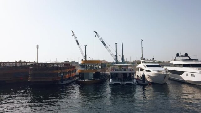 Dubai Marina: Tourist Dhows, Luxury Yachts & Boats Docked Under Clear Sky