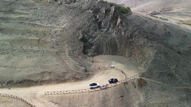 Aerial drone view over basalt rock natural monument in Porto Santo island, Madeira, Portugal. Long golden beach with transprent water.