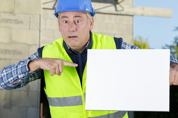 worker pointing his finger to a blank board © auremar
