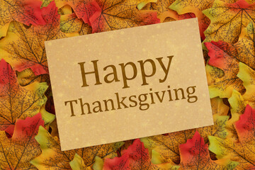 Happy Thanksgiving greeting card on autumn leaves