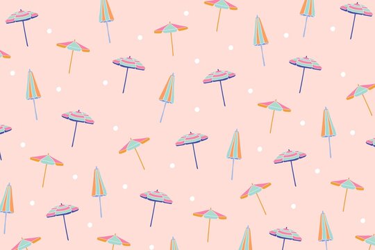 A colorful pattern of beach umbrellas on a pink background with white polka dots