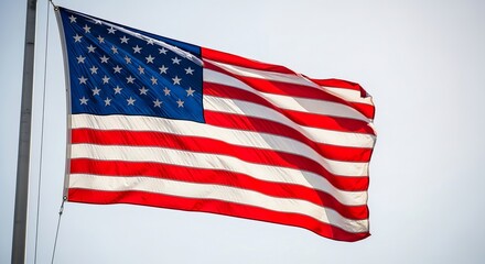Obraz premium American flag waving proudly in the wind with vibrant colors and stars