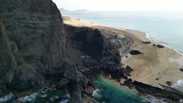 Stunning aerial view of Ponta da Calheta, Porto Santo island, Madeira, Portugal. Long sandy beach and mountains. Paradise with transparent water