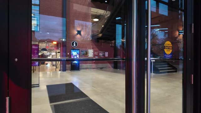 Flashing Firetruck Lights Reflect on Glass Door of a Building