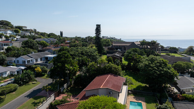 Aerial view of Ballito coastal residential area with ocean and tropical houses, South Africa