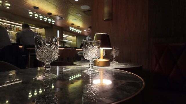Wine Glasses on Table in Speakeasy Bar With Blurred Background