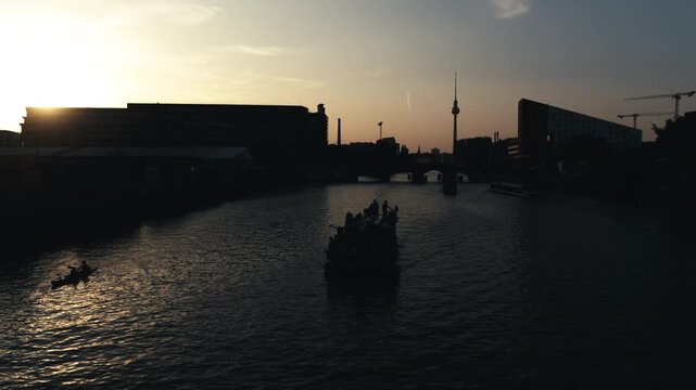 Party boat on River Spree Berlin at sunset with TV Tower 
