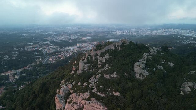 Aerial drone view around Pena Palace, Moorish castle and Village Palace from ex Portuguese monarchy. Sintra town, Lisbon, Portugal