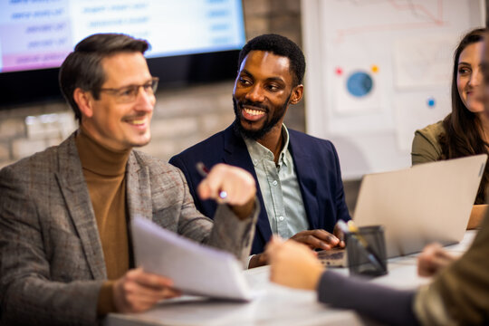 Professional recruitment team examining a candidate's CV during a formal interview.