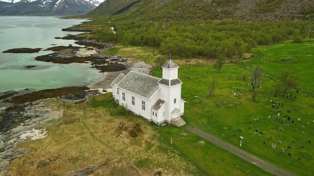 Aerial images of Iglesia de Gims&oslash;y (Gims&oslash;y kirke) in Lofoten, Norway, during a sunny day, 4k 30 fps, drone video