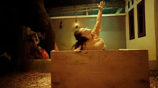 Horror Scene of a Possessed Woman's Breakdown Inside a Box