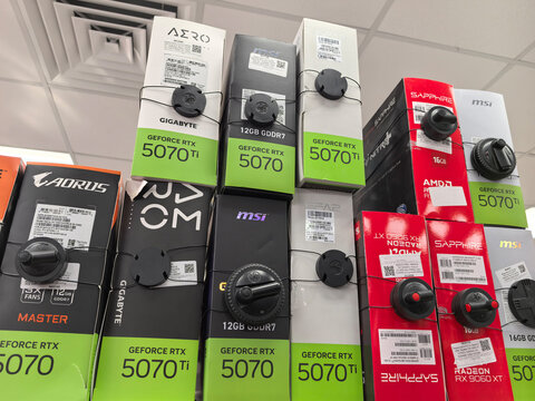 Colorful display of graphics cards in a tech store on a sunny afternoon