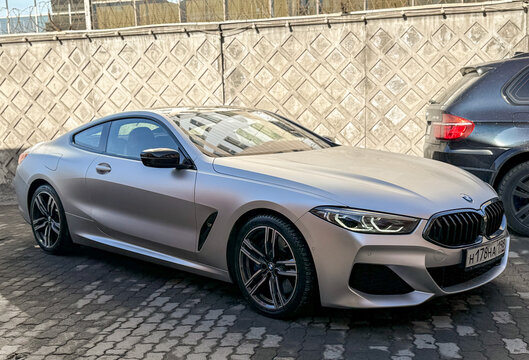 Gray matte BMW 8 series 840d xDrive II (G14,G15,G16) parked on street, luxury car exterior. Vehicle exterior sport car of the BMW 8. The modern exterior of a premium silver BMW 8 series 840d xDrive. 