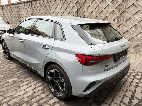 A nardo gray 
Audi A3 Sportback 35 TFSI IV (8Y) parked on street, luxury car exterior. The modern exterior of a premium Germany sportback hatchback car Audi A3 gray color. VAG Group. 