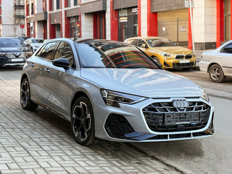 A nardo gray 
Audi A3 Sportback 35 TFSI IV (8Y) parked on street, luxury car exterior. The modern exterior of a premium Germany sportback hatchback car Audi A3 gray color. VAG Group. 