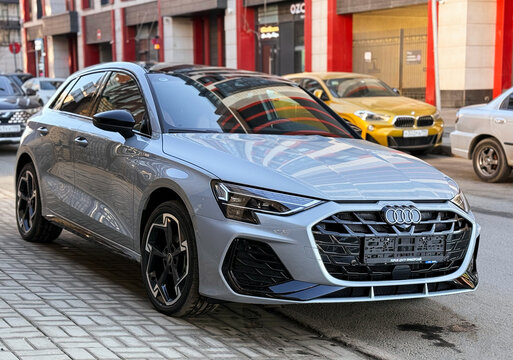 A nardo gray 
Audi A3 Sportback 35 TFSI IV (8Y) parked on street, luxury car exterior. The modern exterior of a premium Germany sportback hatchback car Audi A3 gray color. VAG Group. 