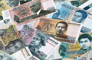Cambodian riel money banknotes pile on table. Cambodia bills of KHR currency close up © Larysa