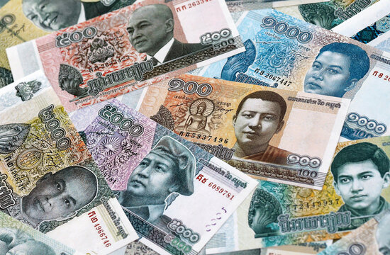 Cambodian riel money banknotes pile on table. Cambodia bills of KHR currency close up