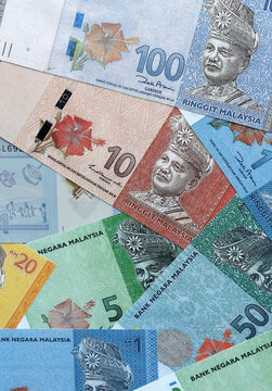 Malaysian ringgit money banknotes pile on table. Malaysia bills of MYR currency close up