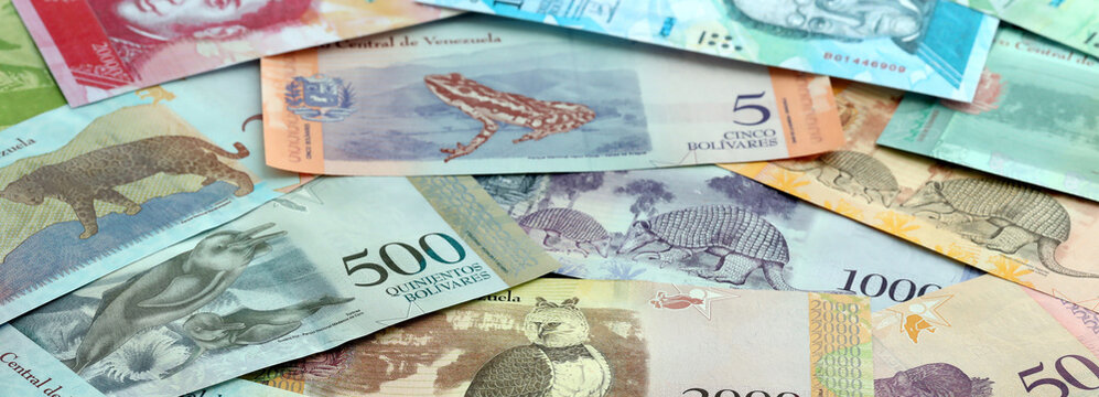 Venezuelan bolivar money banknotes pile on table. Venezuela bills of VES currency close up
