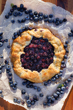 Blueberry galette on a white baking paper. Delicious homemade pastry