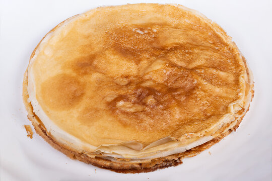 Elegant crepe layers. Delicate caramelized pancake sheets. Artisan style thin pancake layers with caramel spots. Soft edged crepes featuring gentle browning and caramelized spots