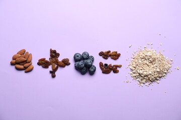 Obraz premium Math equation of oat flakes and other ingredients on lilac background, flat lay