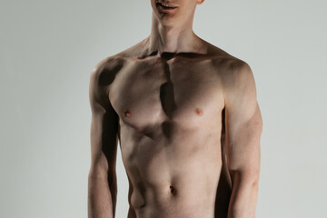 Fototapeta premium the body of an athletic young man without clothes. Concept: men's health, prominent abdominal muscles, clean skin