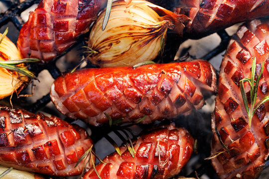 Grilled sausages on a cast iron grill, close up view