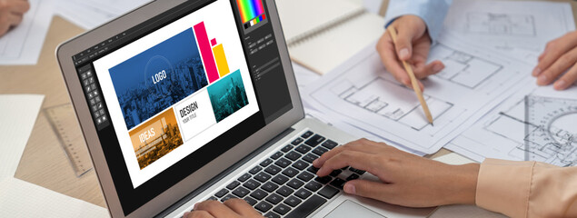 Graphic designer software for modern design of web page and commercial brisk ads showing on the computer screen