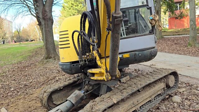 Mini excavator parked on a construction site, close-up.