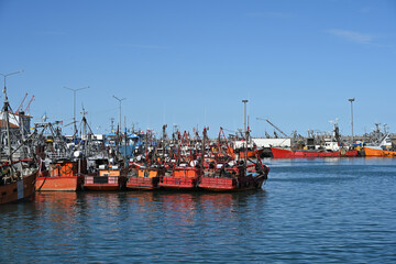 Fototapeta premium fishing boats in port, construction site with crane