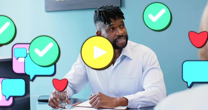 Manager presenting in business meeting, gesturing, sipping, causing icons expanding over documents