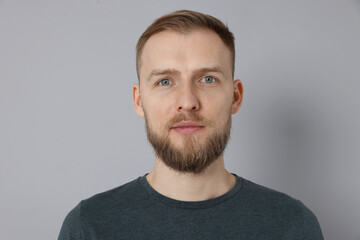 Fototapeta premium Portrait of handsome man on light grey background