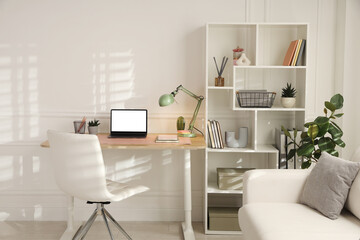 Fototapeta premium Stylish workplace with modern laptop on wooden desk in office