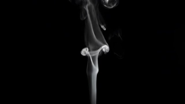 White smoke rising in thin wisps on solid black background