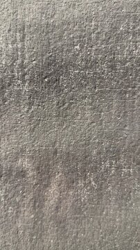 Close-up rolled roofing texture vertical granules, asphalt membrane with coarse grit and parallel ridges, neutral gray tones, macro.