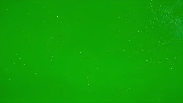 Tiny white particles swirling with erratic motion on green screen chroma background
