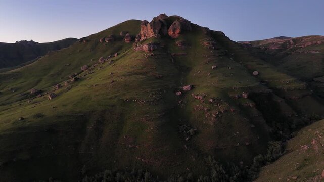 Sunset Green Hill Rocky Outcrop South Africa Panoramic Aerial Shot At Dusk With Warm Light Casting Long