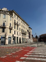 Fototapeta premium view of the beautiful old building and a red crosswalk in milan, Italy