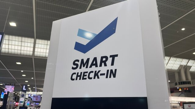 Smart Check-in terminal interactive kiosk by infotouch at Narita International Airport showing automated flight registration system and signage - Chiba, Japan, October 29, 2025
