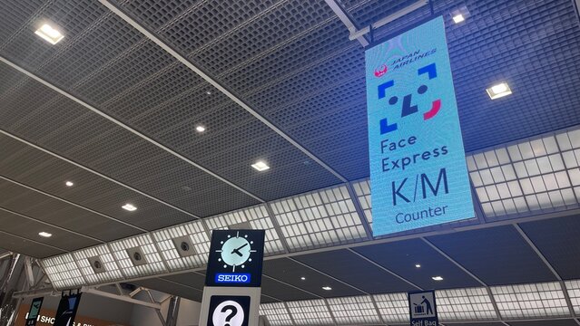 Narita International Airport digital signage near Bus and Taxi Stand Information counter showing Japan Airlines Face Express check-in - Chiba, Japan, October 29, 2025