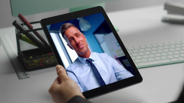 Smiling manager chatting web camera tablet call with coworker at office closeup