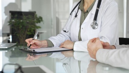 Doctor woman discussing medical information with patient during a healthcare consultation in a...